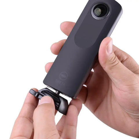 Hand attaching camera to Quick Release Flat And Curved Surface Camera Mount With Strong Adhesive Base for secure use.