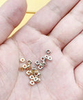 Hand holding 2000 Pcs 4mm Flat Round Disc Spacer Beads For Bracelet And Necklace Making, Silver And Gold Tone CCB Spacers
