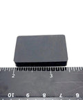 Rectangle Silicone Rubber Bumper Feet One And One Half Inch By One Inch Three Sixteenth Inch Thick shown with ruler