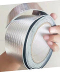 Hand holding two rolls of Butyl Repair Tape Sealant for roof leaks, pipe cracks, and outdoor surfaces, heavy duty waterproof tape.