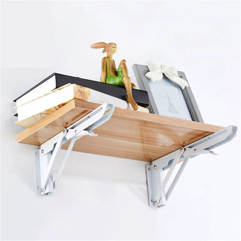 Two Pack Heavy Duty Folding Shelf Brackets Stainless Steel Collapsible Mounts with wood shelf and decor items