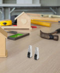 Top Notch 4 Piece Sliding Door Rollers With Slippery Smooth Track Pulleys For Wardrobe And Closet Sets featuring silver rollers on a workbench.