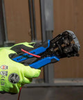 Gloved hand holding Self-Adjusting Wire Stripper And Cutter, Heavy Duty, Cuts And Strips 10-20 AWG Solid And 12-22 AWG Stranded tool