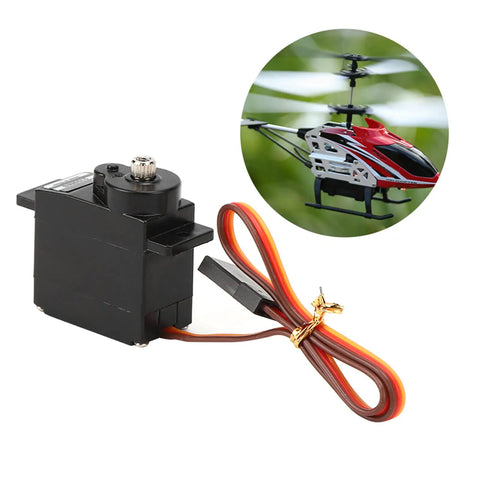 Badass 10g Metal Gear Micro Servo Featuring Solid Core Motor And Lightning Fast Digital Response For 450 Rc Helicopter Builds And Tight Control Upgrades That Go Hard On The Field, black with wires, next to RC helicopter.