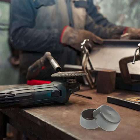 Workshop scene with black reusable Four Pack Rubber Bearing Caps For Trailer Wheel Hub And Bearing on table