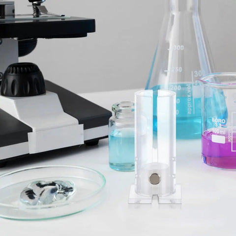Sturdy Acrylic Mouse Restrainer Tube Fixture With Pretty Darn Secure Grip For Zero Fuss Abdominal And Tail Vein Injections Sweet Spot Lab Gear For Healthy Little Rodents Up To Thirty Five Grams Straightforward Equipment For Busy Labs on lab table with experiment equipment.