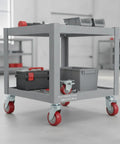 Red Polyurethane Plate Caster With Steel Core For Warehouse Carts And Service Trolleys on a gray cart in warehouse
