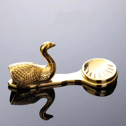 Gold swan-shaped stainless steel cutlery holder on sleek surface, part of Durable Utensil Stand For Restaurant And Home Dining Tables