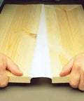 Hands pulling apart wooden panels sealed with Big Stretch Caulk 10.5 Oz White Heavy Duty Flexible Acrylic Latex Sealant For Interior And Exterior Use Stretches Up To 500 Percent And Seals Gaps Up To 2 Inches Low VOC Strong Adhesion Durable Waterproof Caulking.