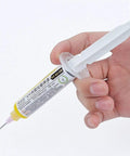 Yellow UV Soldering Paste Flux 10cc for PCB BGA use with syringe and push needle, held in hand for precise repairs.