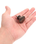 Person holding 12 Pack Round Antique Brass Cabinet Pulls Single Hole Small Flat Head Metal Drawer Handles for Kitchen and Bath Cabinets