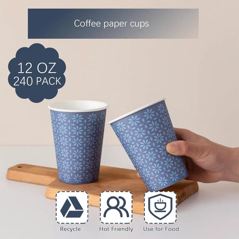 12 Oz Navy Floral Disposable Paper Cups, Image of 240 Pack 12 Oz Disposable Paper Cups Navy Floral Hot And Cold Bev Cups For Home Office Restaurant And Events Leak Proof With Rolled Rim And Poly Lined Interior, hand holding one of the cups