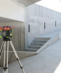 Heavy Duty Electronic Self Leveling Rotary Red Laser Level Kit on tripod in construction area for horizontal alignment.