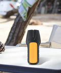 3-in-1 Wall Scanner Stud Finder for Wood Metal and Live Wire Detection, Electronic Sensor Detector for Pipe AC Cable Home Renovation DIY Projects on a table outdoors.