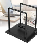 Newtons Cradle Pendulum Desk Toy For Home Office Decor A Real Classic Nerdy Yet Cool Science Showpiece With Durable Steel Balls And Plastic Frame An Educational Physics Toy For Kids And Adults 17.8 x 14.8 x 18 cm on a desk