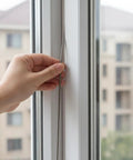Hand inserting a 1/4 inch foam strip backer rod into a window gap for sealing preparation. Grab This Cool 26 Ft Backer Rod For Your DIY Projects!