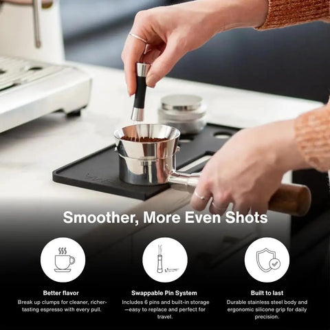 Using Weiss Distribution Technique WDT Tool for coffee grounds evenness with stainless steel and silicone grip for espresso.