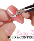 Close-up of a pink acrylic nail held with tweezers, highlighting the Magnetic Nail Stand Set For Press Ons Acrylic Nail Holder And Display Kit.