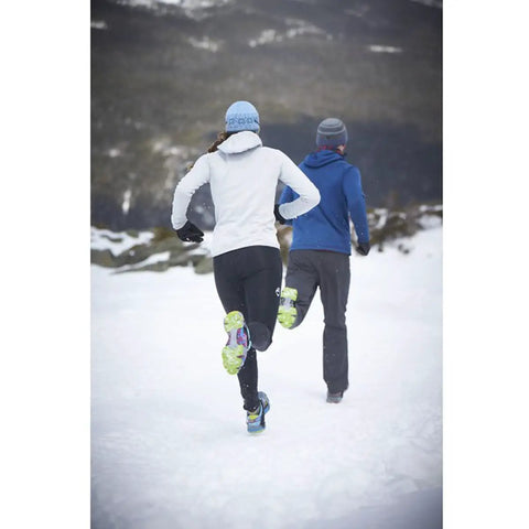 Runners wearing Ice Traction Cleats For Running Shoes, Lightweight Grip With Full Sole Coverage, Cleats On Heel And Forefoot in snow