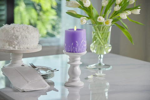 Flameless Moving Flame Goblet Candle With LED Pillar 4 By 4.5 Inch Embossed Floral Print Unscented Real Wax Recessed Edge Timer Remote Ready Lavender Glow on table