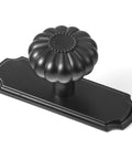 Matte Black Cabinet Knobs With Scalloped Backplates 6 Pack Featuring Slick Fluted Floral Handles And A Beaded Center Medallion detail view of scalloped backplate and fluted knob.