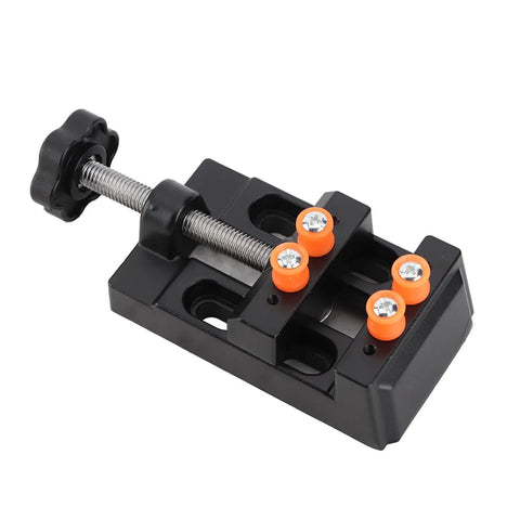 Premium Mini Vise In Solid Aluminum Alloy For Milling Drilling And Bench Work Secure Clamping Table With Four Fixed Curve Grooves Perfect For Wood Jade And Metal Carving Projects Durable Steel Jaws For Precision Gripping, black bench vise with adjustable clamp and orange accents.