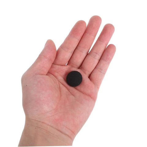 Close-up of a hand holding a black snap rivet from the 12 Set Car Roof Headliner Repair Kit With Black Snap Rivets Retainers For Easy Interior Ceiling Fixing No Disassembly Required Quick And Durable For A Clean Seamless Interior Look Easy DIY Fix Fits Most Cars Durable Snap Rivets And Retainers.