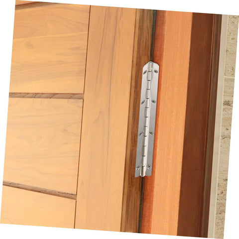 Piano hinge on wooden cabinet door, silver metal finish, mounted with screws.
