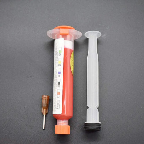 Red UV Solder Mask Kit 10Ml With 1 Needle And Push Tool For PCB BGA Painting DIY Friendly Anti Corrosion Arcing Soldering Paste Flux Cream Welding Flux Oil 1 To 10 Micron Particle Size, featuring syringe and needle on dark surface.