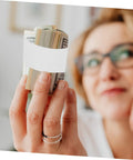 Heavy Duty Cash Strapping Tape Roll For Banknote Bundling And Shipping, woman holding bundles with white paper tape