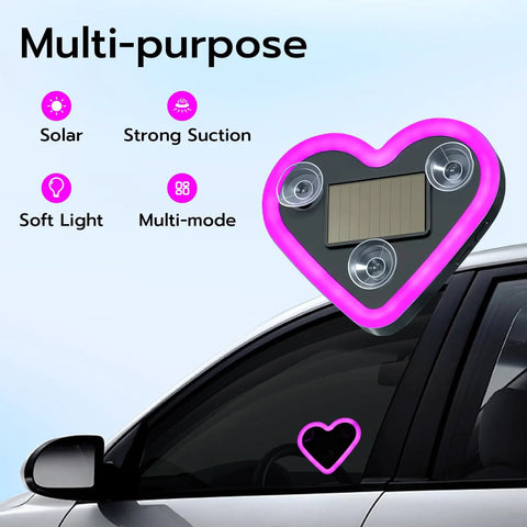 Heart Shaped Car LED Ambient Light With Solar Rechargeable Power attached to car window, showing suction cups and solar panel.