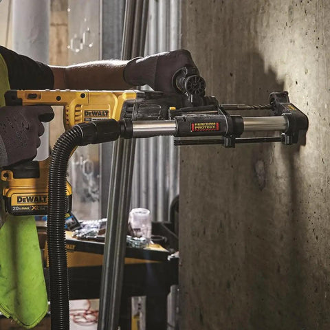 Worker using Dust Extractor Telescope With Hose For SDS Rotary Hammers Black Pro Grade Attachment on concrete wall.