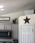 Rustic Metal Barn Star Wall Decor Made From Recycled Iron With Vintage Finish on kitchen wall above door.