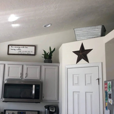 Rustic Metal Barn Star Wall Decor Made From Recycled Iron With Vintage Finish on kitchen wall above door.