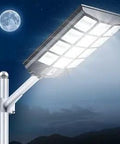 Ultra Bright 1500W Solar Street Light With Wide Angle Beam illuminating night sky, mounted on pole, IP65 Weatherproof