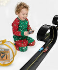 Child playing with Flexible Race Car Track Set With Pressure Suction Cups, Two Lane Slot Track, includes bag and two cars.