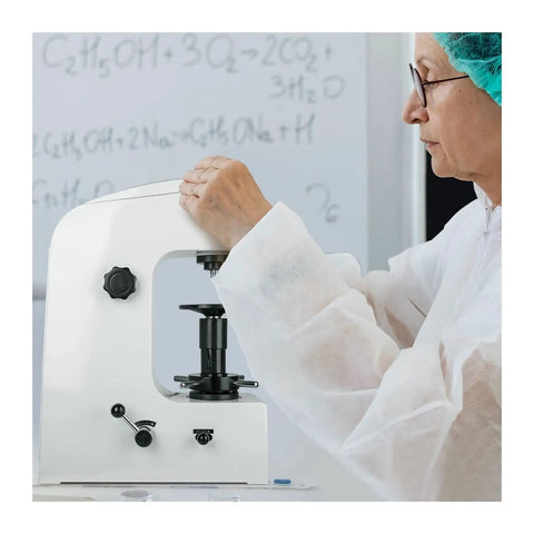 Built Like A Tank Rockwell Hardness Tester Machine Featuring Superficial Scales HRC HRA HRB And Solid Calibration Blocks For Heat Treated Steel And Soft Metals Up To 150 Kg being operated by a person in a lab coat.