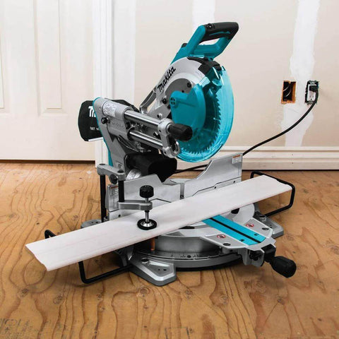 Makita LS1019L 10-inch dual-bevel sliding miter saw with laser, turquoise blade guard on a metal stand.