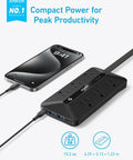 Sleek Power Strip With 300J Surge Protection And 5 Foot Extension Cord Serving Up Pretty Dang Fast Charging Across Six AC Outlets Paired With Dual USB A And Type C Ports For A Smooth No Stress Desk Setup, showing device beside smartphone.