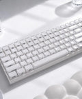 Wireless Mechanical Keyboard With Number Pad And Dynamic RGB Lighting Featuring Playful Jelly Cat Keycaps And Buttery Smooth Linear Switches For Your Dope Desk Setup Or Epic PC Gaming Nights, showcasing white keycaps on a smooth surface.