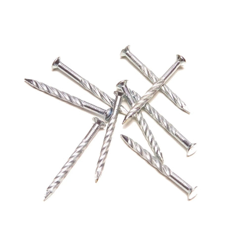 Premium Carbon Steel Floor Screws Silver 1.25 Inch 13 Gauge Nails scattered on a white background for flooring projects.