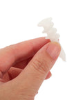 White Plastic Drywall Anchors Kit With 300 Pieces For Heavy Duty Drywall Repair And Installation held between fingers close-up