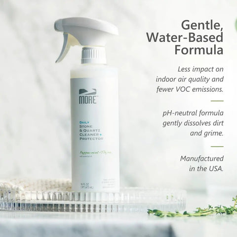 All In One Stone And Quartz Cleaner And Protector Spray For Granite Marble And Quartz Surfaces On Kitchen And Bath Counters And Floors Water Based Neutral PH Formula With Peppermint Thyme Essential Oil 16 Oz bottle on a tray.