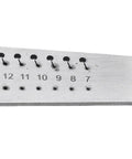 Close-up of a 36 Hole Watchmakers Tap And Die Set Stainless Steel Micro Tool Kit on a durable steel board