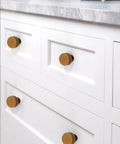 Close-up of Antique Brass Kitchen Cabinet Knobs 10 Pack Zinc Drawer Pulls installed on white cabinets