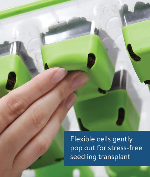 Hand demonstrating flexibility of SuperSeed All In One Seed Starting Tray With 16 XL Cells, showing pop-out silicone cell feature.