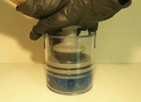 Portable Self Contained Grease Repack System for bearings up to three and a half inches in use, flushing out old grease.