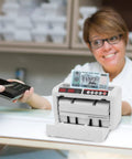 Portable Digital Money Counter With UV And MG Detection, 800 Bills Per Minute in use at a bank counter.