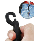 Front view of black plastic swivel snap keychain clip held by fingers, showing curved J-hook design
