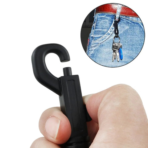 Front view of black plastic swivel snap keychain clip held by fingers, showing curved J-hook design